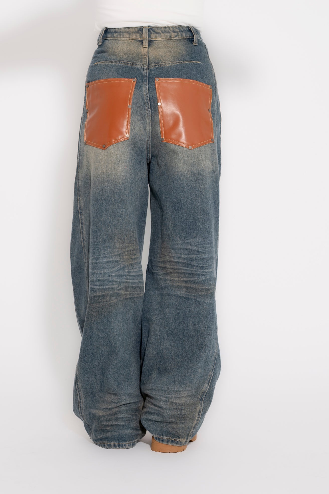 Jeans sabbiato con tasche in pelle